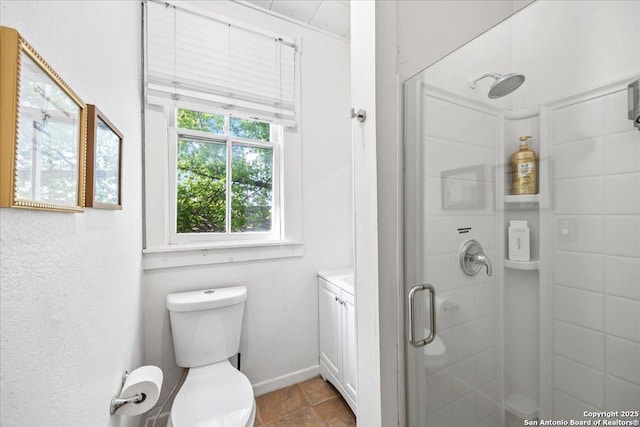 bathroom featuring toilet, tile patterned flooring, and a stall shower