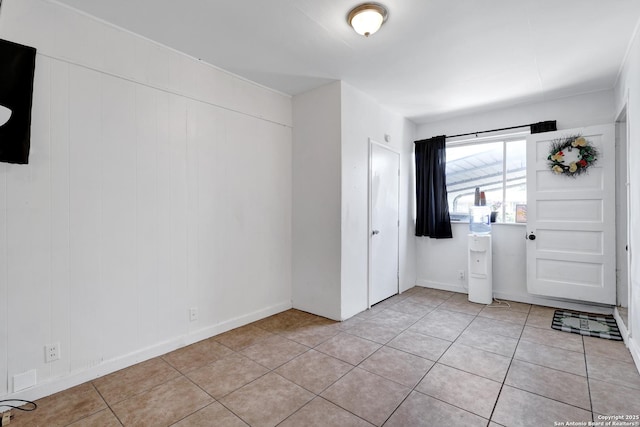 foyer entrance with light tile patterned flooring and baseboards