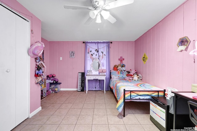 bedroom with a ceiling fan, baseboards, and light tile patterned floors
