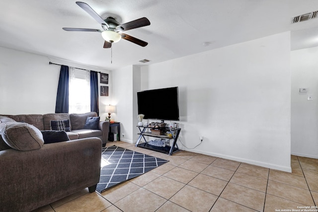 living area with baseboards, a ceiling fan, visible vents, and light tile patterned floors
