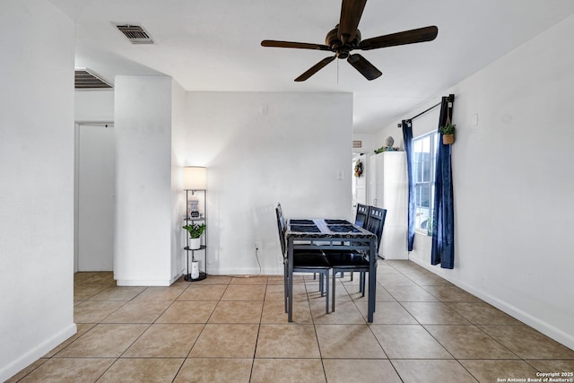dining room with baseboards, a ceiling fan, visible vents, and light tile patterned floors