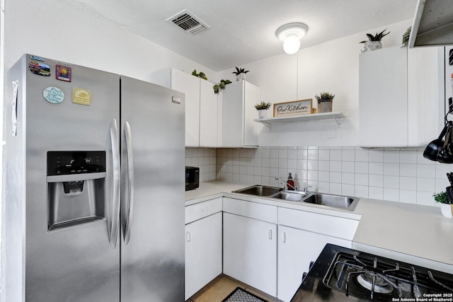 kitchen with light countertops, visible vents, tasteful backsplash, and stainless steel fridge with ice dispenser