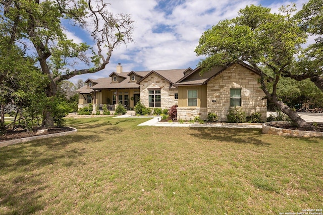 110 Madrone Trl, Boerne, TX 78006 - view of front of house with stone siding, covered porch, a front lawn, and a chimney
