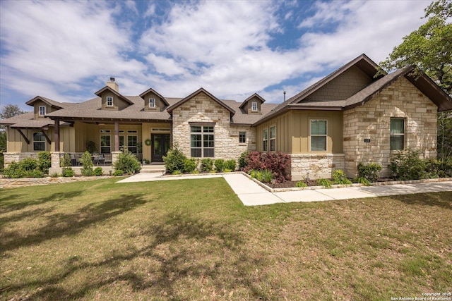 110 Madrone Trl, Boerne, TX 78006 - craftsman house featuring a chimney, stone siding, board and batten siding, a porch, and a front yard