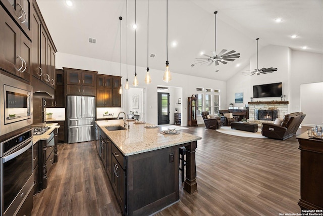 110 Madrone Trl, Boerne, TX 78006 - kitchen with a sink, high vaulted ceiling, ceiling fan, a fireplace, and appliances with stainless steel finishes