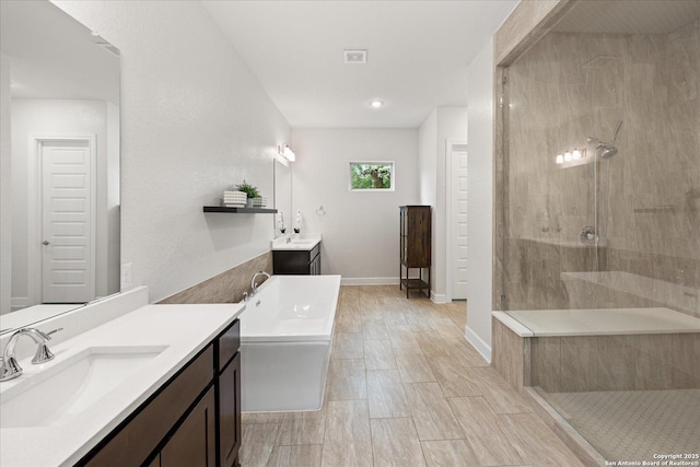 110 Madrone Trl, Boerne, TX 78006 - bathroom with a tile shower, a sink, baseboards, a bathtub, and two vanities