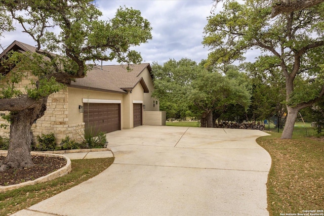 110 Madrone Trl, Boerne, TX 78006 - view of property exterior with stucco siding, an attached garage, concrete driveway, stone siding, and roof with shingles