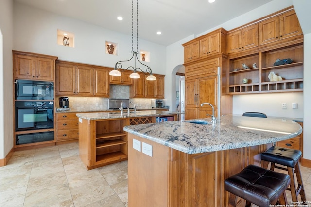 4001 Bell Springs Rd, Dripping Springs, TX 78620 - kitchen with black appliances, an island with sink, open shelves, and a sink