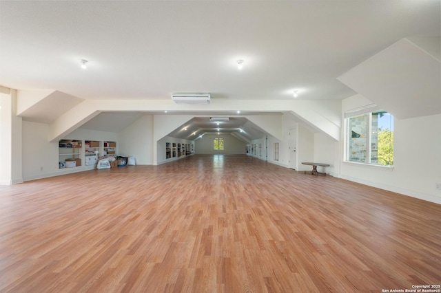 4001 Bell Springs Rd, Dripping Springs, TX 78620 - additional living space featuring lofted ceiling, baseboards, wood finished floors, and a wall mounted AC