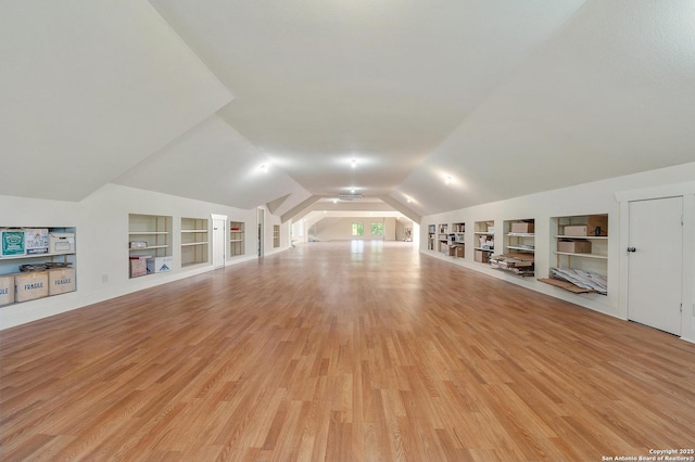 4001 Bell Springs Rd, Dripping Springs, TX 78620 - bonus room with built in shelves, vaulted ceiling, and light wood-style floors