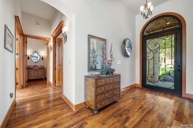 4001 Bell Springs Rd, Dripping Springs, TX 78620 - entryway with an inviting chandelier, baseboards, wood finished floors, and arched walkways