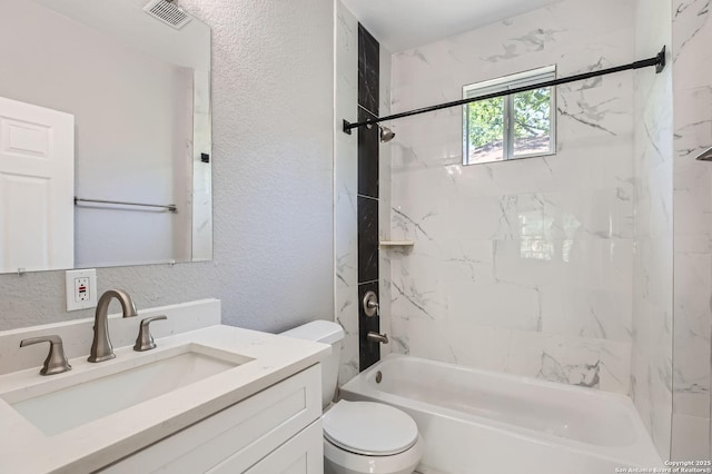 full bath with toilet, visible vents, a textured wall, vanity, and tub / shower combination