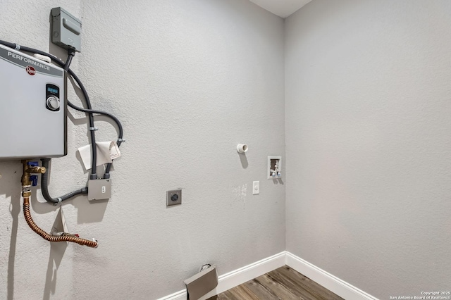 washroom with hookup for an electric dryer, baseboards, hookup for a washing machine, wood finished floors, and laundry area