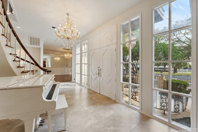 foyer featuring a chandelier, stairway, visible vents, and light tile patterned floors