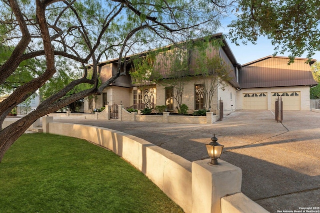 view of front of property with an attached garage, a front yard, and concrete driveway