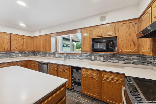 kitchen with a sink, decorative backsplash, brown cabinets, stainless steel appliances, and light countertops