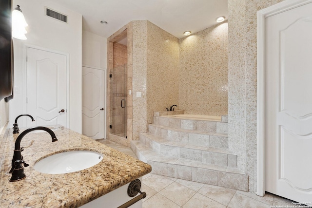 full bathroom with tile patterned floors, a stall shower, visible vents, a garden tub, and vanity