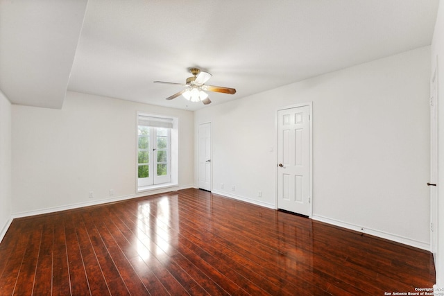 spare room with wood finished floors, baseboards, and ceiling fan