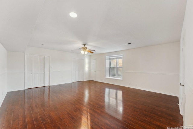 empty room with baseboards, wood finished floors, and ceiling fan