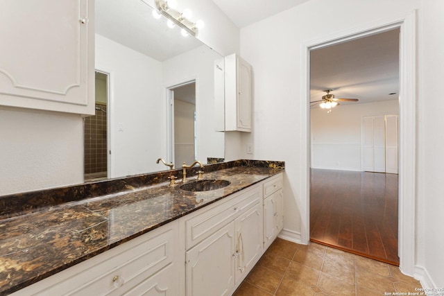 bathroom featuring vanity, baseboards, a ceiling fan, and tile patterned flooring