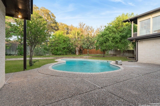 view of swimming pool with a fenced backyard, a patio, a fenced in pool, and a lawn