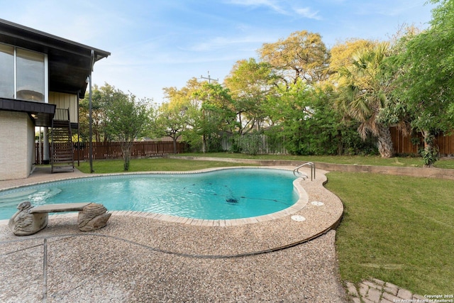 view of swimming pool featuring stairs, a yard, a fenced in pool, and a fenced backyard