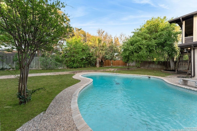 view of pool featuring stairway, a lawn, a fenced backyard, and a fenced in pool