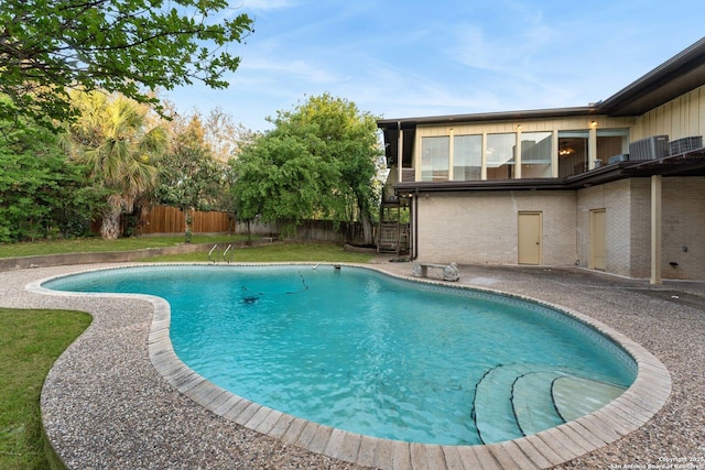 view of swimming pool featuring fence, a patio, a fenced in pool, and stairway