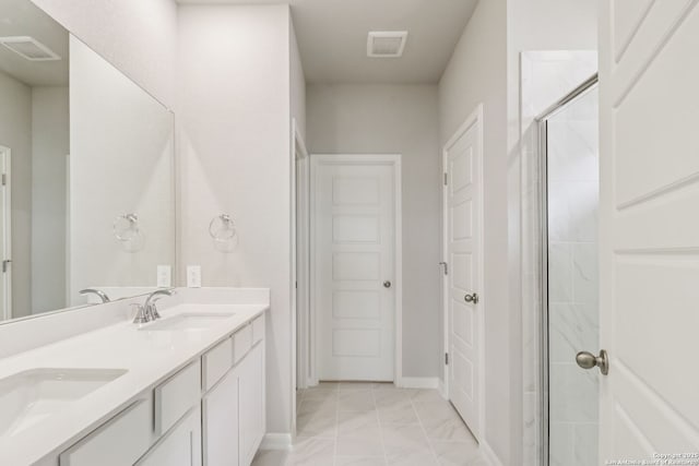 9814 Prairie Way, San Antonio, TX 78245 - bathroom with double vanity, marble finish floors, and a shower stall