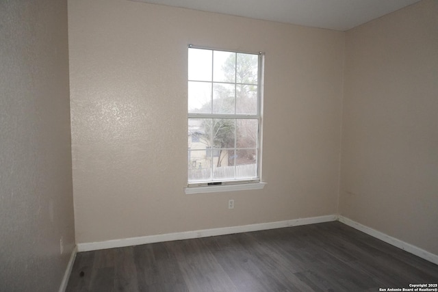 8826 Dream Ave, Converse, TX 78109 - unfurnished room with dark wood finished floors, plenty of natural light, and baseboards