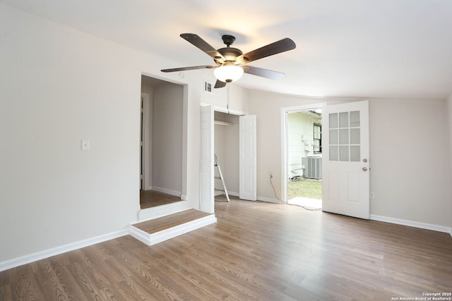 unfurnished room with visible vents, baseboards, a ceiling fan, and wood finished floors