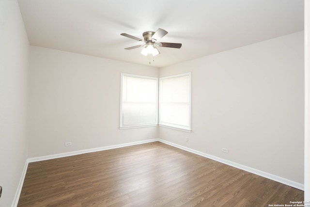 unfurnished room with baseboards, dark wood-style floors, and ceiling fan
