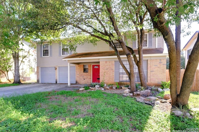 view of front of home with a garage, driveway, and brick siding