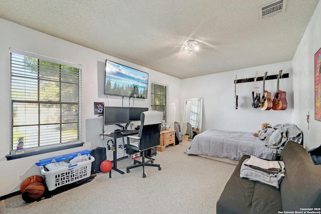 carpeted bedroom with a textured ceiling and visible vents