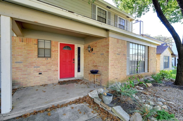 property entrance with brick siding