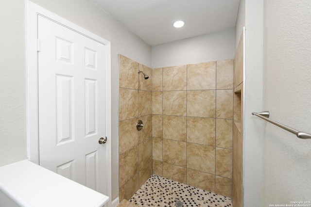 full bathroom with recessed lighting and a tile shower