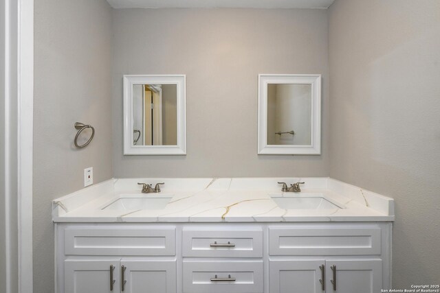 full bathroom featuring a sink and double vanity