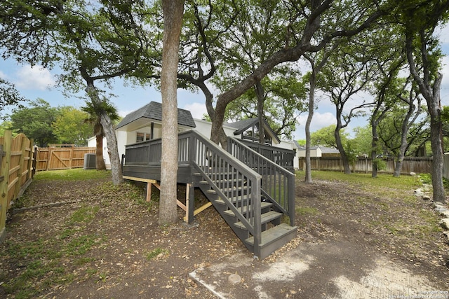 wooden terrace featuring a fenced backyard, central AC, and stairs