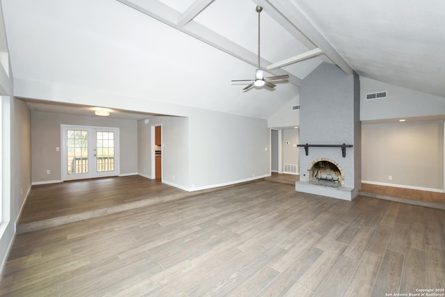 unfurnished living room with beamed ceiling, visible vents, a ceiling fan, and a fireplace