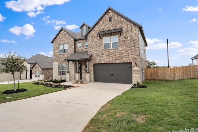 view of front of home with driveway, fence, a garage, brick siding, and a front yard