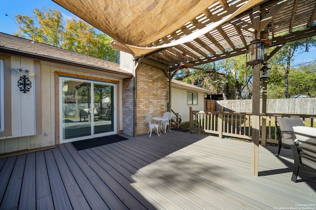 wooden terrace featuring a pergola and fence