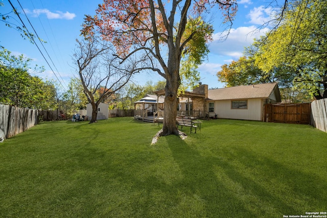 view of yard with a gazebo, a storage unit, a fenced backyard, and an outdoor structure