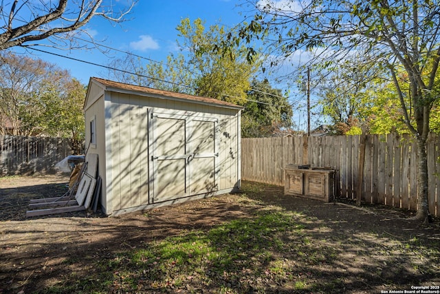 view of shed with a fenced backyard