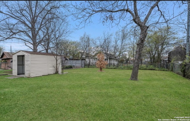 1244 Clower, San Antonio, TX 78201 - view of yard featuring a storage unit, an outdoor structure, and a fenced backyard