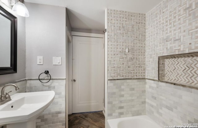 1244 Clower, San Antonio, TX 78201 - full bathroom featuring tile walls, wainscoting, wood finished floors, and a sink