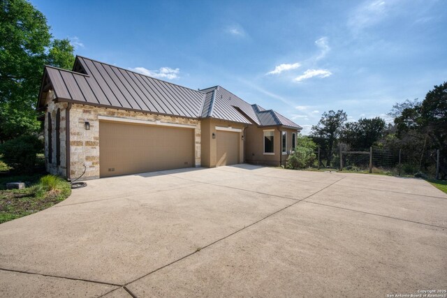 114 Riverwalk, Boerne, TX 78006 - view of front of home featuring concrete driveway, a standing seam roof, metal roof, and an attached garage