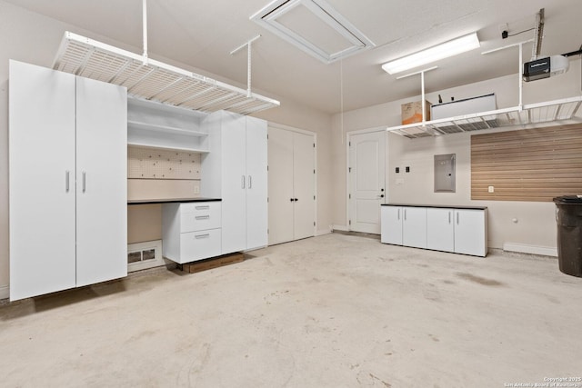 114 Riverwalk, Boerne, TX 78006 - garage with a garage door opener, electric panel, and baseboards