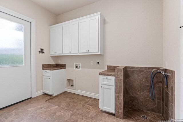 114 Riverwalk, Boerne, TX 78006 - laundry area featuring hookup for a washing machine, hookup for an electric dryer, cabinet space, and baseboards
