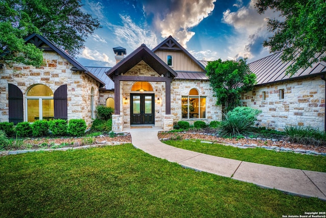 114 Riverwalk, Boerne, TX 78006 - craftsman-style house with a standing seam roof, french doors, a front lawn, and stone siding