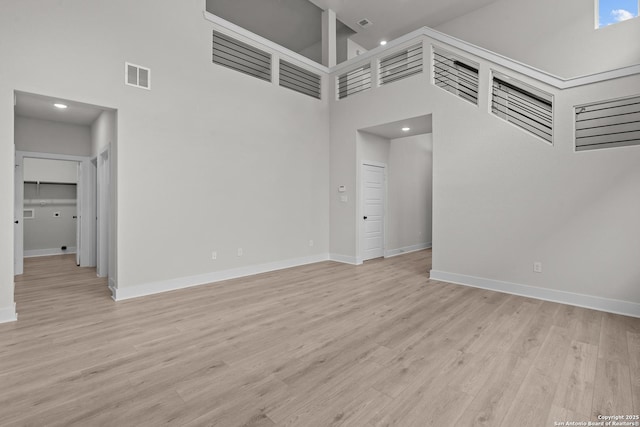 133 Bailey Blf, San Antonio, TX 78253 - unfurnished living room featuring visible vents, baseboards, and a high ceiling